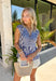 Nothing says effortless spring style quite like navy and white stripes. This classic collared top by Fate gets a fresh update with a flattering front tie detail that adds just the right touch of charm. Crisp yet relaxed, it’s the kind of piece you’ll reach for on sunny mornings, weekend brunch dates, and everything in between. Lightweight and breathable in 100% cotton, this striped beauty pairs perfectly with white denim, cutoffs, or your favorite wide-leg jeans for that easy coastal-inspired look.