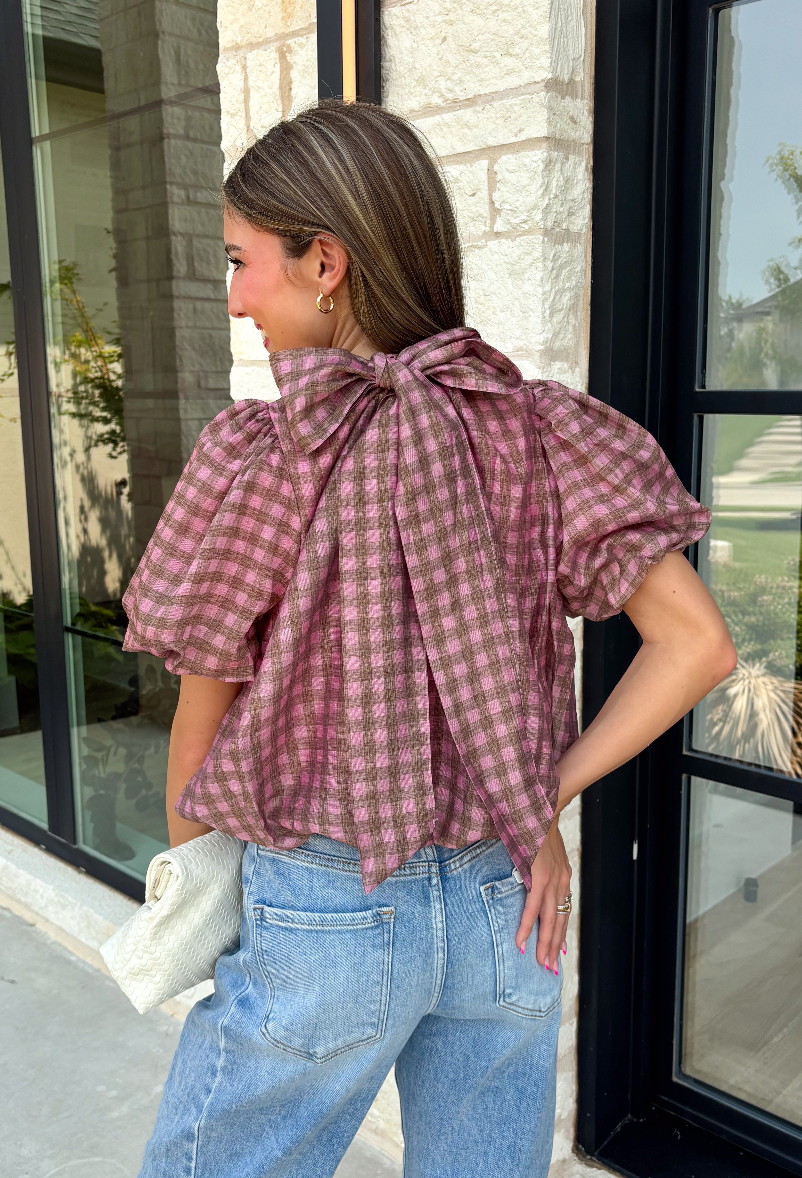 Sweet gingham and thoughtful details make this blouse an instant favorite for the season. Featuring a charming pink and brown gingham print, this lightweight top brings a fresh, feminine touch to your fall wardrobe. The mock neckline with a tie detail at the neck, puff sleeves, and bubble hem create a flattering silhouette that's both polished and comfortable. 
