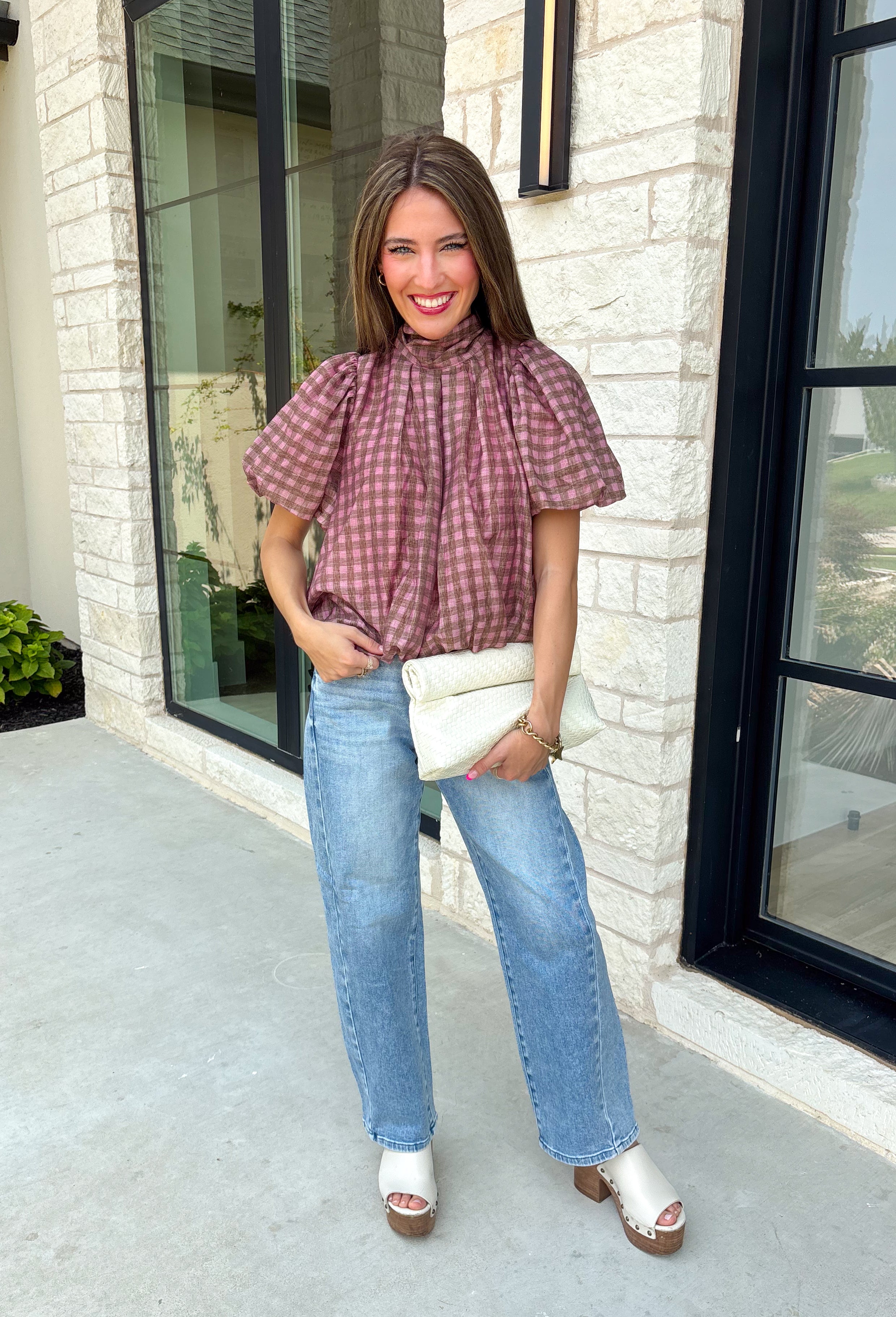 Sweet gingham and thoughtful details make this blouse an instant favorite for the season. Featuring a charming pink and brown gingham print, this lightweight top brings a fresh, feminine touch to your fall wardrobe. The mock neckline with a tie detail at the neck, puff sleeves, and bubble hem create a flattering silhouette that's both polished and comfortable. 