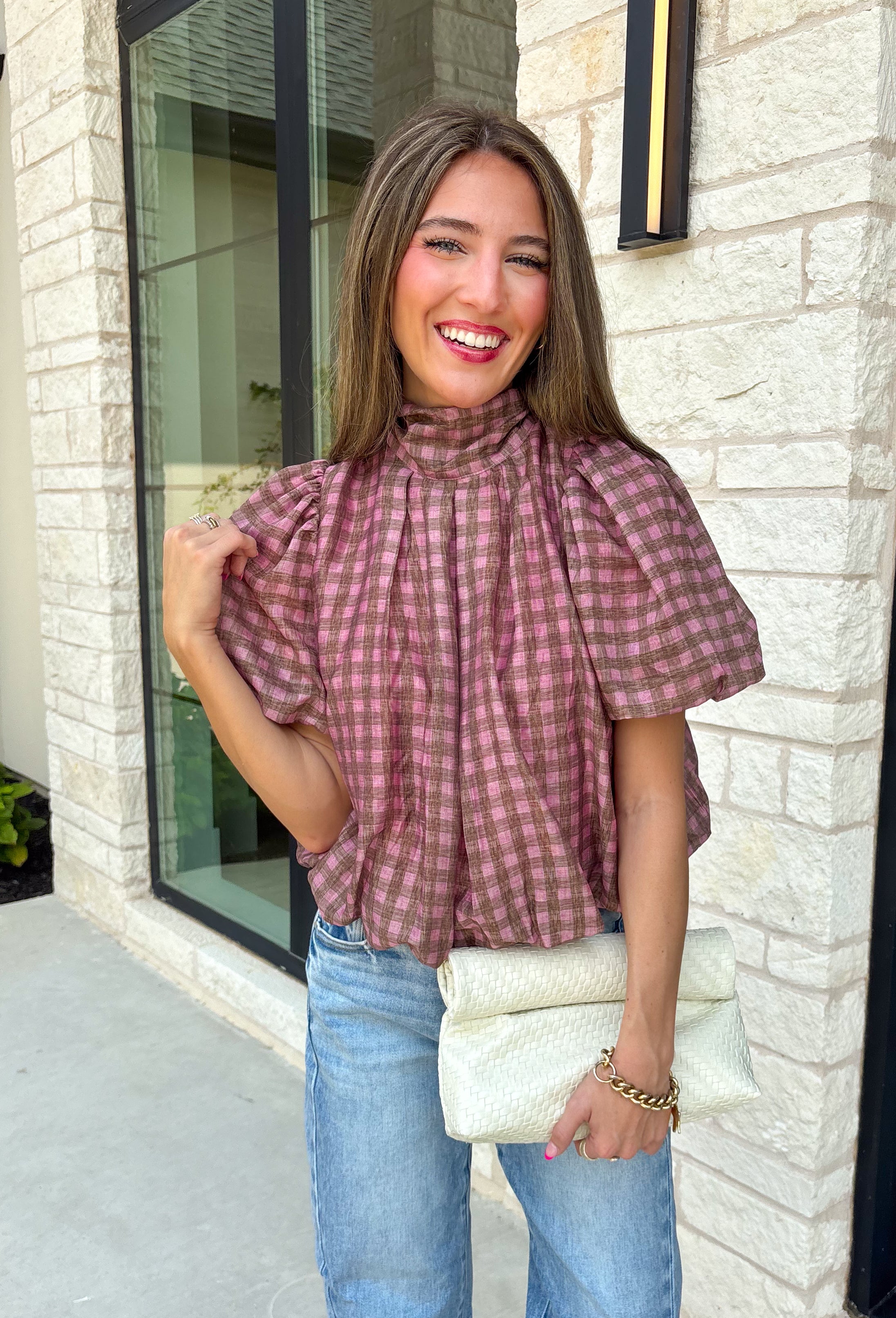 Sweet gingham and thoughtful details make this blouse an instant favorite for the season. Featuring a charming pink and brown gingham print, this lightweight top brings a fresh, feminine touch to your fall wardrobe. The mock neckline with a tie detail at the neck, puff sleeves, and bubble hem create a flattering silhouette that's both polished and comfortable. 