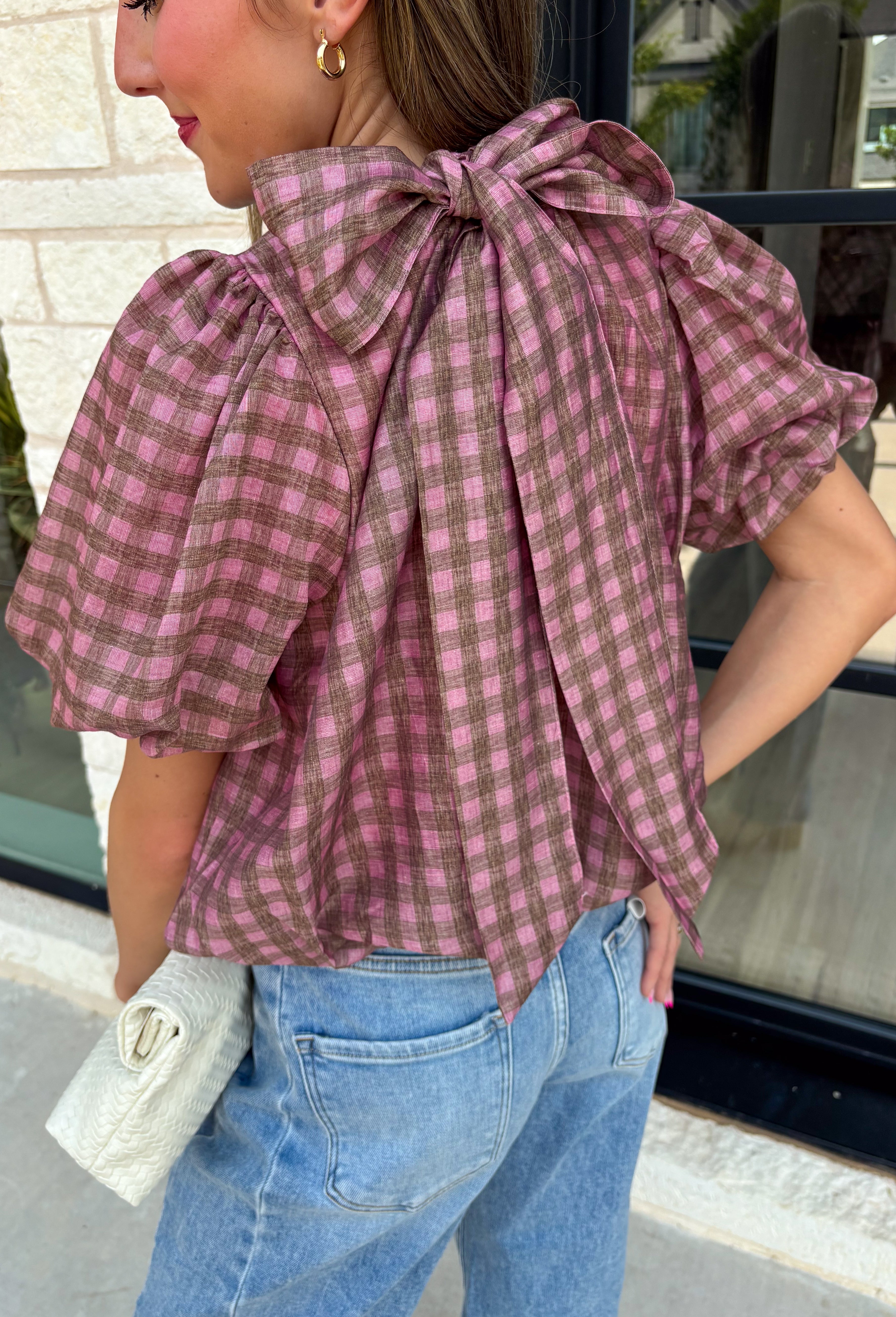 Sweet gingham and thoughtful details make this blouse an instant favorite for the season. Featuring a charming pink and brown gingham print, this lightweight top brings a fresh, feminine touch to your fall wardrobe. The mock neckline with a tie detail at the neck, puff sleeves, and bubble hem create a flattering silhouette that's both polished and comfortable. 