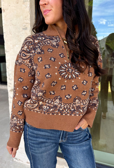 Wrap yourself in cozy comfort with this western-inspired pullover from Current Air. Designed in a warm camel hue, this soft knit features a timeless bandana-inspired pattern in black and off-white for a look that's both classic and eye-catching. The quarter zip neckline adds a sporty touch while making it easy to layer throughout the season. Cozy, versatile, and effortlessly stylish, this sweater is perfect for everything from weekend outings to crisp fall mornings.