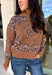 Wrap yourself in cozy comfort with this western-inspired pullover from Current Air. Designed in a warm camel hue, this soft knit features a timeless bandana-inspired pattern in black and off-white for a look that's both classic and eye-catching. The quarter zip neckline adds a sporty touch while making it easy to layer throughout the season. Cozy, versatile, and effortlessly stylish, this sweater is perfect for everything from weekend outings to crisp fall mornings.