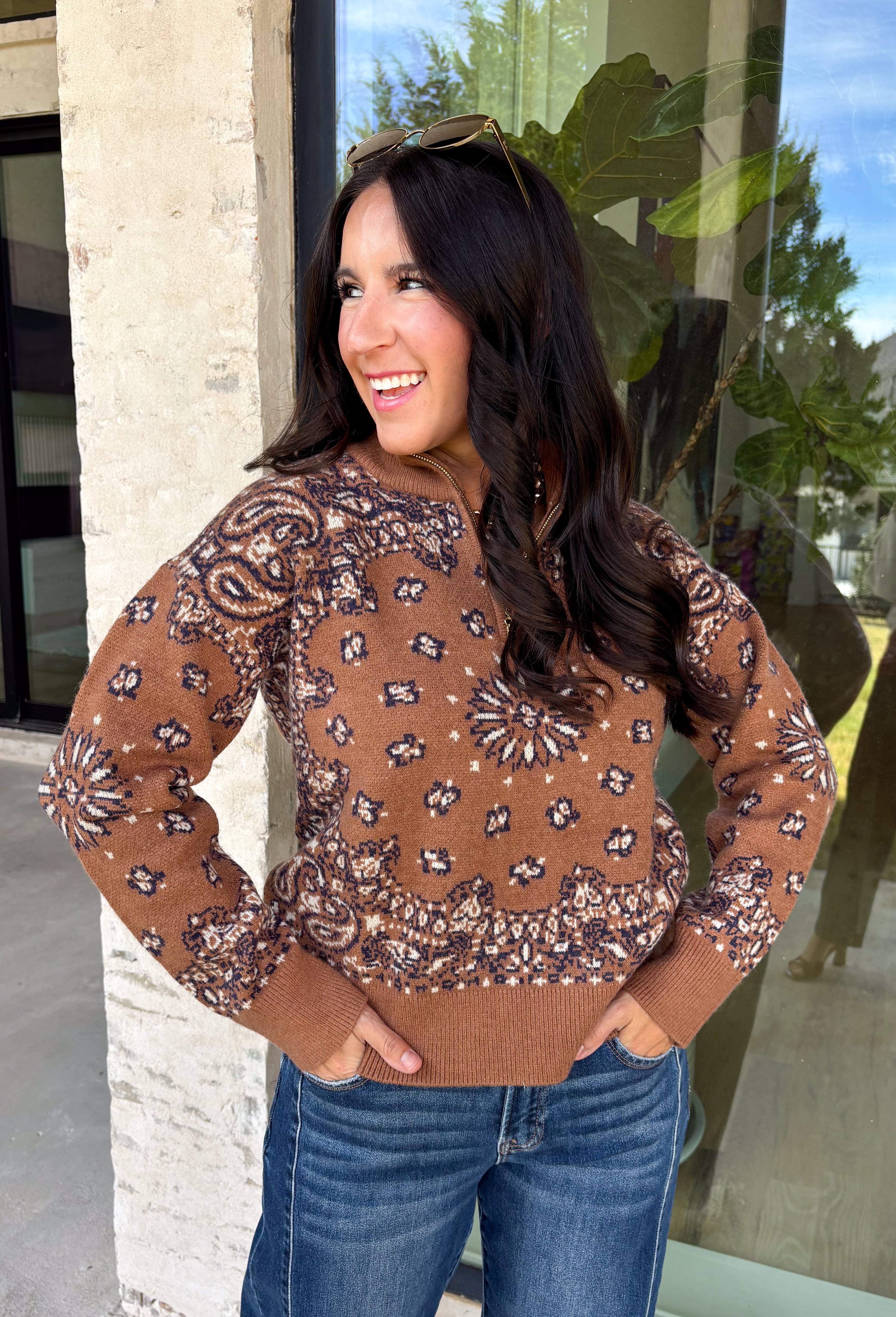 Wrap yourself in cozy comfort with this western-inspired pullover from Current Air. Designed in a warm camel hue, this soft knit features a timeless bandana-inspired pattern in black and off-white for a look that's both classic and eye-catching. The quarter zip neckline adds a sporty touch while making it easy to layer throughout the season. Cozy, versatile, and effortlessly stylish, this sweater is perfect for everything from weekend outings to crisp fall mornings.