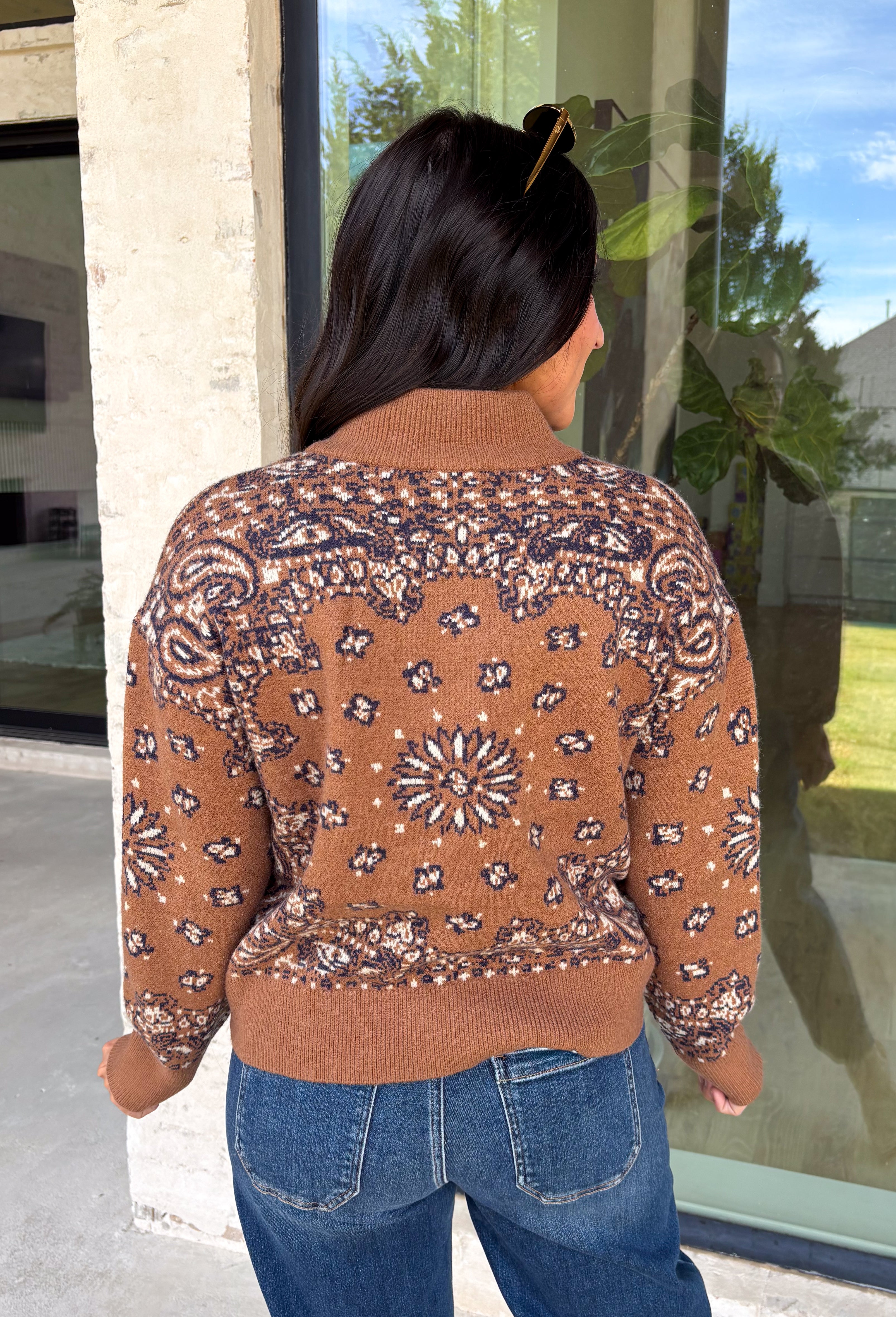 Wrap yourself in cozy comfort with this western-inspired pullover from Current Air. Designed in a warm camel hue, this soft knit features a timeless bandana-inspired pattern in black and off-white for a look that's both classic and eye-catching. The quarter zip neckline adds a sporty touch while making it easy to layer throughout the season. Cozy, versatile, and effortlessly stylish, this sweater is perfect for everything from weekend outings to crisp fall mornings.