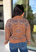 Wrap yourself in cozy comfort with this western-inspired pullover from Current Air. Designed in a warm camel hue, this soft knit features a timeless bandana-inspired pattern in black and off-white for a look that's both classic and eye-catching. The quarter zip neckline adds a sporty touch while making it easy to layer throughout the season. Cozy, versatile, and effortlessly stylish, this sweater is perfect for everything from weekend outings to crisp fall mornings.