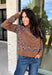 Wrap yourself in cozy comfort with this western-inspired pullover from Current Air. Designed in a warm camel hue, this soft knit features a timeless bandana-inspired pattern in black and off-white for a look that's both classic and eye-catching. The quarter zip neckline adds a sporty touch while making it easy to layer throughout the season. Cozy, versatile, and effortlessly stylish, this sweater is perfect for everything from weekend outings to crisp fall mornings.