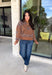 Wrap yourself in cozy comfort with this western-inspired pullover from Current Air. Designed in a warm camel hue, this soft knit features a timeless bandana-inspired pattern in black and off-white for a look that's both classic and eye-catching. The quarter zip neckline adds a sporty touch while making it easy to layer throughout the season. Cozy, versatile, and effortlessly stylish, this sweater is perfect for everything from weekend outings to crisp fall mornings.