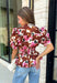 A beautiful floral blouse is one of those pieces you'll reach for all season long, and this one is full of thoughtful details you'll love! Designed with a soft neutral background, this feminine top is adorned with rich brown and pink florals accented by subtle pops of black for the perfect autumn-inspired palette. The flattering self-tie waist creates a customizable silhouette, while the smocked back offers a comfortable fit that moves with you throughout the day.