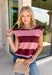 Bring rich autumn color to your everyday wardrobe with this effortlessly stylish striped knit sleeveless sweater. Featuring timeless burgundy and mauve stripes with contrast trim detailing, this sweater knit is the perfect blend of classic and cozy. The cap sleeves and lightweight feel make it easy to wear on its own during warmer fall days or layered under your favorite jacket as the season cools.