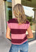 Bring rich autumn color to your everyday wardrobe with this effortlessly stylish striped knit sleeveless sweater. Featuring timeless burgundy and mauve stripes with contrast trim detailing, this sweater knit is the perfect blend of classic and cozy. The cap sleeves and lightweight feel make it easy to wear on its own during warmer fall days or layered under your favorite jacket as the season cools.