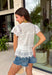 This white floral eyelet lace top is the definition of a timeless summer staple! The delicate eyelet detail adds beautiful texture, while the button down design keeps it classic and easy to style. Lightweight and breathable in 100% cotton, it’s perfect for warm days when you want to feel polished without overthinking it. Whether you're heading to brunch, work, or a casual outing, this top pairs effortlessly with everything from denim shorts to skirts. 