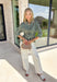 Fresh colors and flattering details make this striped blouse an easy favorite for the season. Designed with soft mint and brown stripes, this effortlessly polished top features a classic v-neckline and button-front design for timeless appeal. The adjustable drawstring waist creates a flattering, customizable fit, while the ¾-length sleeves with button cuffs add a refined finishing touch. Crafted from breathable cotton, this versatile blouse transitions seamlessly from workdays to weekend outings.