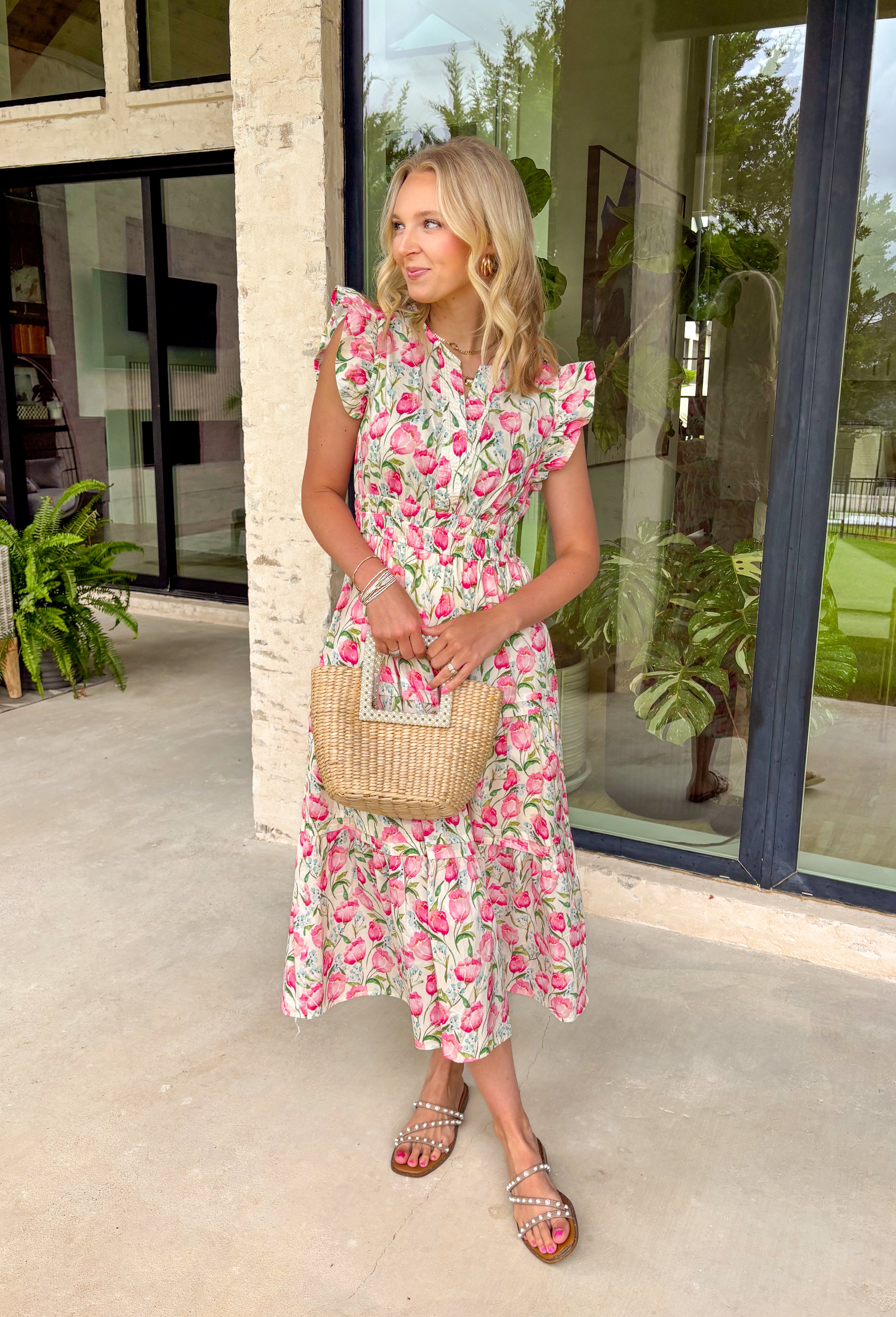 This neutral floral midi dress is such a soft, feminine favorite for summer! The pink floral print with hints of blue and green adds the prettiest pop of color while still feeling easy and wearable for any occasion. The smocked waist creates a flattering, comfortable fit, and the ruffle sleeves add that extra touch of charm. Finished with a v-neckline, side pockets, and a fully lined design, it’s as functional as it is pretty. Perfect for any warm weather special occasion—just add sandals and go. 