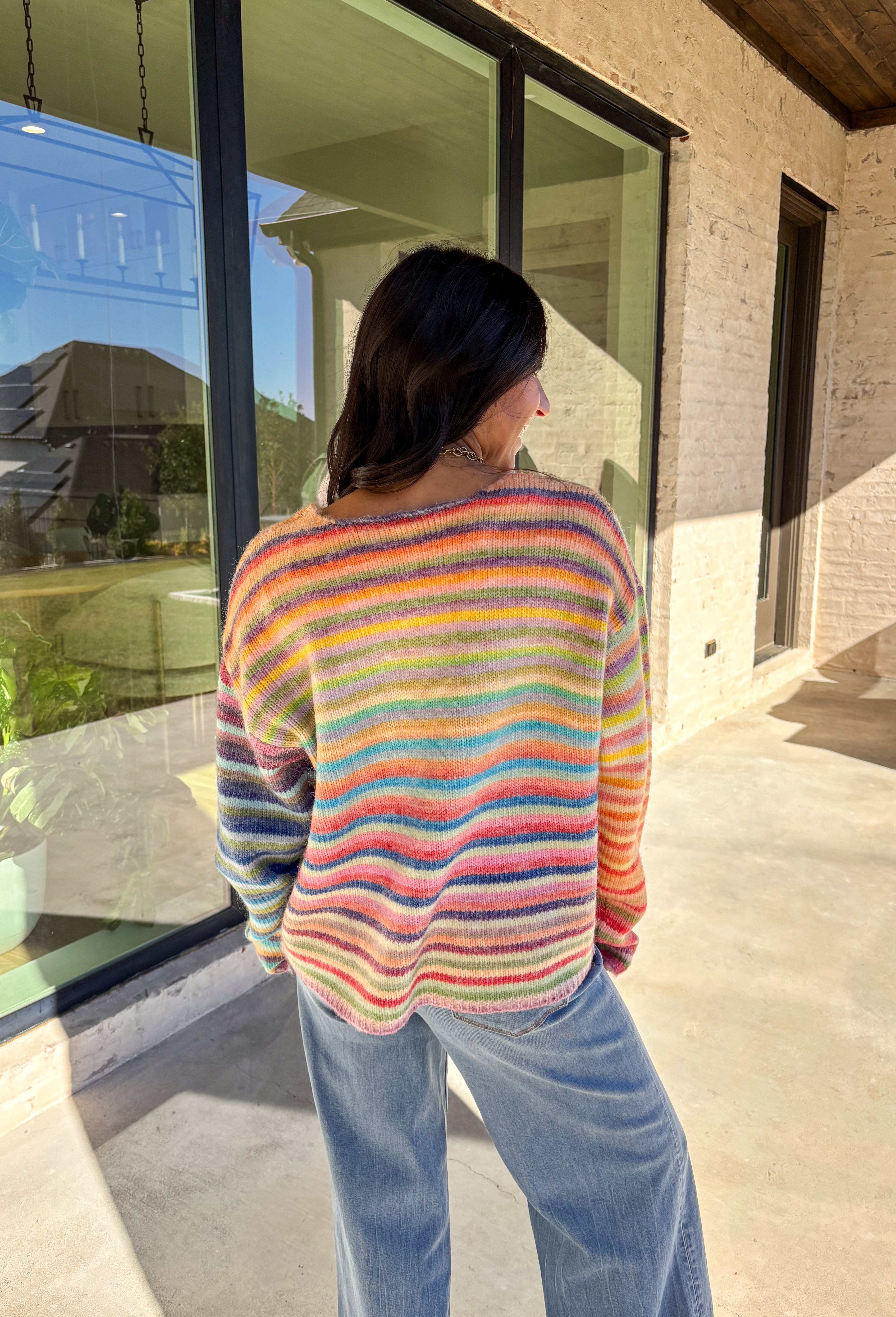 Brighten up chilly days with this cozy stripe knit sweater. Designed in a rainbow of cheerful colors, it’s a fun, feel-good piece that brings instant personality to your wardrobe. The soft knit blend keeps it warm and comfortable, while the relaxed fit makes it perfect for layering with your favorite jeans or skirts. Playful yet versatile, this sweater is the kind of statement piece you’ll wear on repeat all season long.