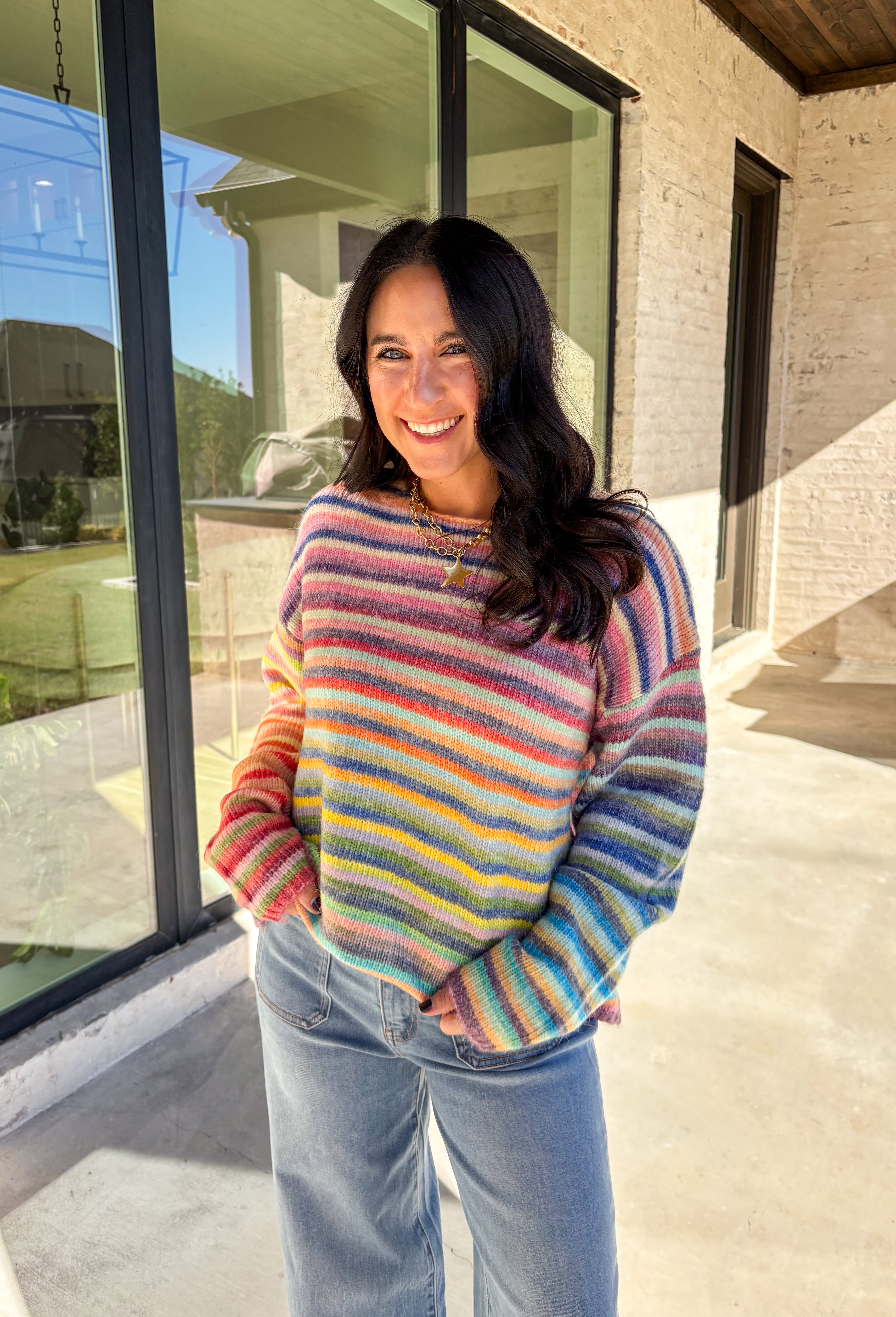 Brighten up chilly days with this cozy stripe knit sweater. Designed in a rainbow of cheerful colors, it’s a fun, feel-good piece that brings instant personality to your wardrobe. The soft knit blend keeps it warm and comfortable, while the relaxed fit makes it perfect for layering with your favorite jeans or skirts. Playful yet versatile, this sweater is the kind of statement piece you’ll wear on repeat all season long.
