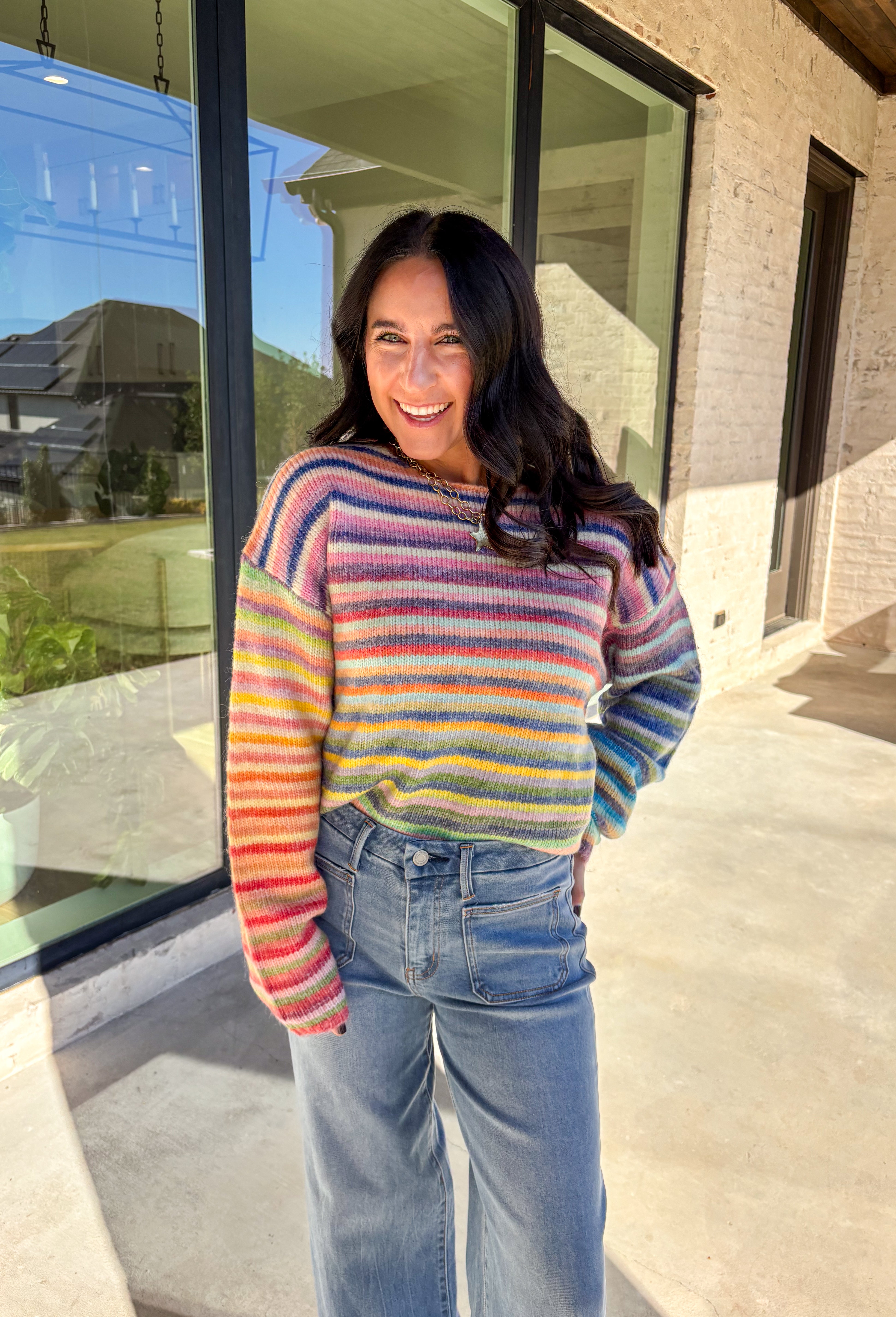 Brighten up chilly days with this cozy stripe knit sweater. Designed in a rainbow of cheerful colors, it’s a fun, feel-good piece that brings instant personality to your wardrobe. The soft knit blend keeps it warm and comfortable, while the relaxed fit makes it perfect for layering with your favorite jeans or skirts. Playful yet versatile, this sweater is the kind of statement piece you’ll wear on repeat all season long.