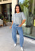 This grey short sleeve sweater is the perfect blend of cozy and classic for the fall season! The soft knit is beautifully finished with ivory scalloped trim along the neckline and sleeves, creating the look of an effortlessly layered outfit without any extra bulk. Its timeless silhouette makes it easy to style for work, weekend outings, or dinner with friends, while the lightweight knit is perfect for those crisp autumn days. 