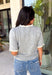 This grey short sleeve sweater is the perfect blend of cozy and classic for the fall season! The soft knit is beautifully finished with ivory scalloped trim along the neckline and sleeves, creating the look of an effortlessly layered outfit without any extra bulk. Its timeless silhouette makes it easy to style for work, weekend outings, or dinner with friends, while the lightweight knit is perfect for those crisp autumn days. 
