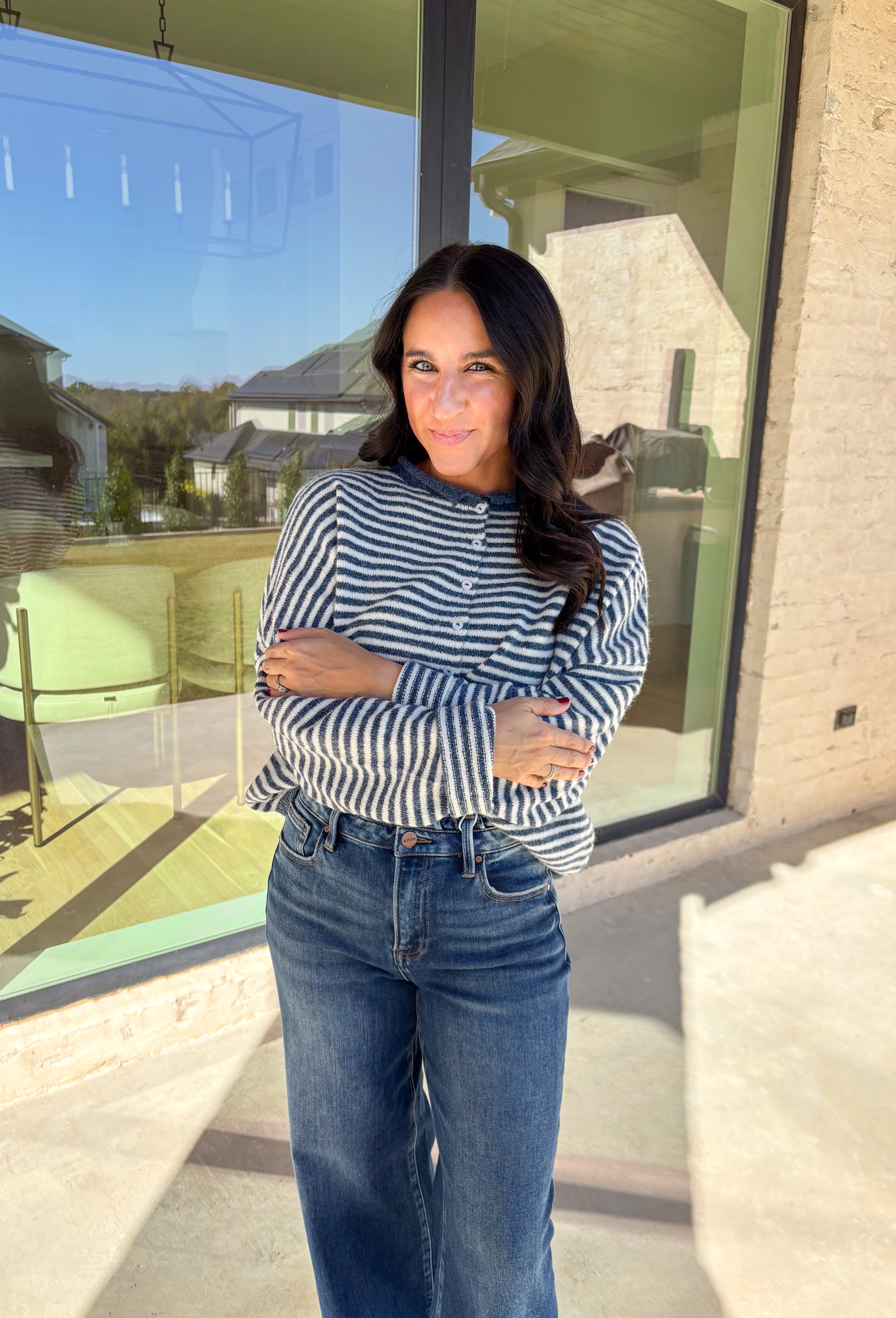 Classic stripes meet cozy comfort in this navy and white button-down cardigan by Things Between. Designed in a soft knit with a relaxed fit, this timeless piece brings effortless warmth to your winter wardrobe. The simple stripe pattern adds a touch of everyday charm, making it easy to style for layering through the colder months.