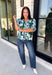 Bring a fresh take on fall florals to your wardrobe with this beautiful hunter green top. Featuring a delicate blue and off white floral print, this timeless top is perfect for everything from office days to weekend outings. The pintuck detailing along the front adds an elevated touch, while the button front and short puff sleeves create a feminine silhouette you'll love season after season. 