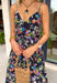 Easy, colorful, and perfect for spring days, this black sleeveless midi dress by Lovestitch is a standout piece you’ll love all season long. Featuring a vibrant floral print with pops of purple, orange, yellow, blue, and pink, this dress brings just the right amount of color to a classic silhouette. The front button details and elastic waist create a flattering, comfortable fit that’s ideal for everything from brunch dates to weekend outings.