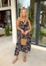 Easy, colorful, and perfect for spring days, this black sleeveless midi dress by Lovestitch is a standout piece you’ll love all season long. Featuring a vibrant floral print with pops of purple, orange, yellow, blue, and pink, this dress brings just the right amount of color to a classic silhouette. The front button details and elastic waist create a flattering, comfortable fit that’s ideal for everything from brunch dates to weekend outings.