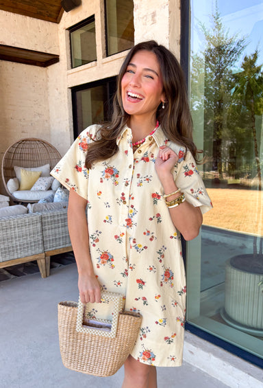 Fresh, fun, and full of spring color, this cream denim dress is an easy standout for the season. Featuring a colorful floral print throughout in shades of red, yellow, blue, and green, it brings a cheerful pop to a classic denim silhouette. The collared neckline and front button details keep it timeless and polished, while side pockets add that everyday functionality we all love. Made from breathable cotton denim, this dress is perfect for spring days when you want something effortless but still eye-catchin