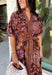 Warm fall color takes center stage in this terra cotta floral midi dress from Entro. Covered in a beautiful floral print featuring shades of the season, it has an autumn-ready look that works for everything from family photos to weekend gatherings. The v-neckline and button-front closure keep the silhouette classic, while short puff sleeves add a sweet touch of volume.