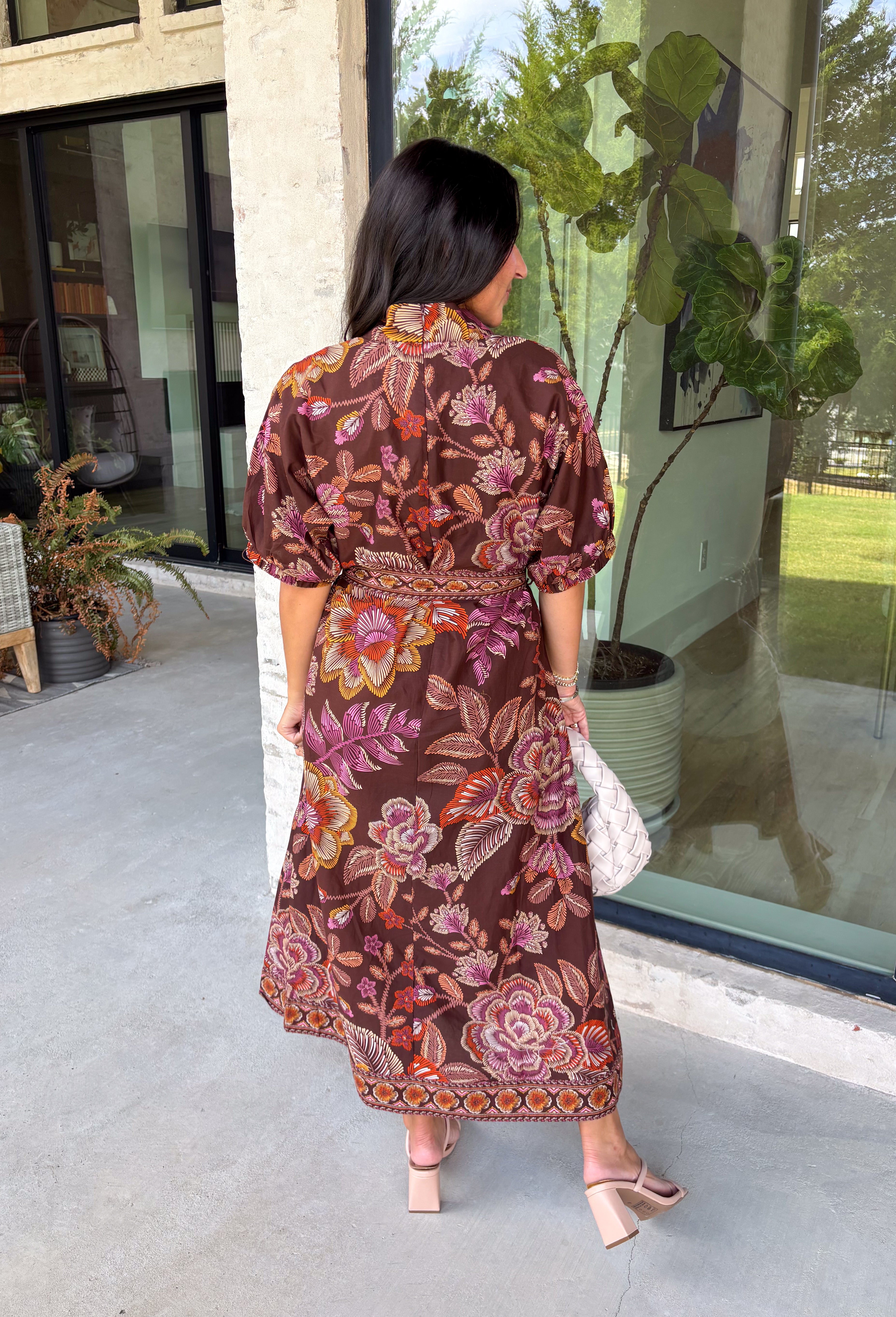 Warm fall color takes center stage in this terra cotta floral midi dress from Entro. Covered in a beautiful floral print featuring shades of the season, it has an autumn-ready look that works for everything from family photos to weekend gatherings. The v-neckline and button-front closure keep the silhouette classic, while short puff sleeves add a sweet touch of volume.