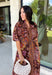 Warm fall color takes center stage in this terra cotta floral midi dress from Entro. Covered in a beautiful floral print featuring shades of the season, it has an autumn-ready look that works for everything from family photos to weekend gatherings. The v-neckline and button-front closure keep the silhouette classic, while short puff sleeves add a sweet touch of volume.