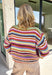 Wrap yourself in all the beautiful colors of the season with this cozy striped sweater. Featuring a gorgeous mix of green, off white, rust, blue, brown, purple, and yellow, this soft knit brings warmth, personality, and effortless style to your everyday wardrobe. The relaxed silhouette makes it perfect for layering on crisp fall mornings or cozy evenings, while the colorful stripes make it an easy statement piece you'll love wearing year after year. 
