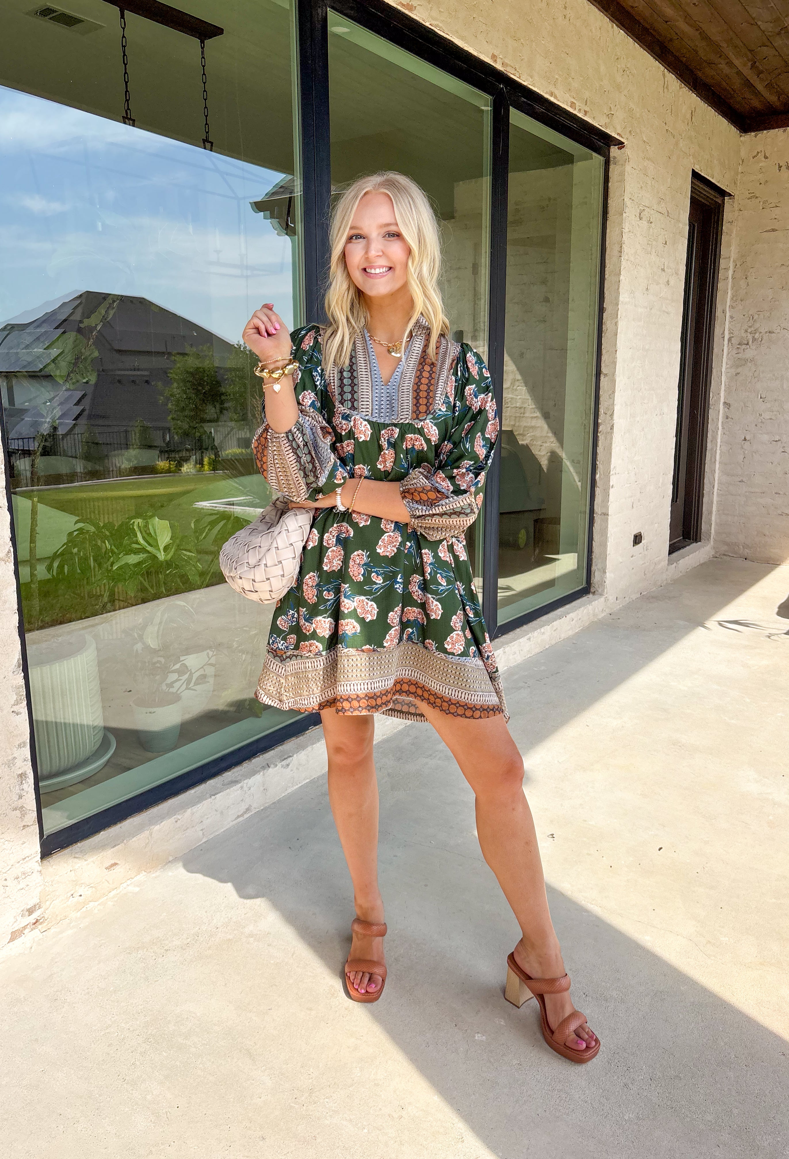 Bring a rich fall palette into your wardrobe with this dark green dress, designed with a mix of seasonal florals. Trimmed in an abstract print along the neckline, hemline, and sleeves, it has an artisan-inspired finish that feels unique and thoughtful. The elastic cuff sleeves add comfort and a touch of volume, while the flowy silhouette and full lining keep it easy to wear from day to night. Accented with shades of brown, this dress is a cozy yet elevated choice for the season.