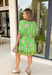 Bring a burst of sunshine to your spring wardrobe with this lime green dress. The lively floral print features playful pops of lilac, green, and white, while the contrasting hem in green, mustard, and white adds a fun, unexpected twist. The button-down front and self-tie belt create a flattering, adjustable fit, and the lightweight fabric keeps it breezy for warm spring days. Whether you’re headed to brunch or strolling the farmers’ market, this dress is all about easy, cheerful style.