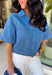 This medium wash denim top is giving effortless spring style in the best way. With its crisp collared neckline, short sleeves, and cropped length, it’s the kind of piece you can throw on and instantly look put together. The chest pockets add that classic denim touch, making it perfect for pairing with high-rise jeans, shorts, or a cute flowy skirt for an easy warm-weather outfit.