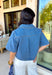 This medium wash denim top is giving effortless spring style in the best way. With its crisp collared neckline, short sleeves, and cropped length, it’s the kind of piece you can throw on and instantly look put together. The chest pockets add that classic denim touch, making it perfect for pairing with high-rise jeans, shorts, or a cute flowy skirt for an easy warm-weather outfit.