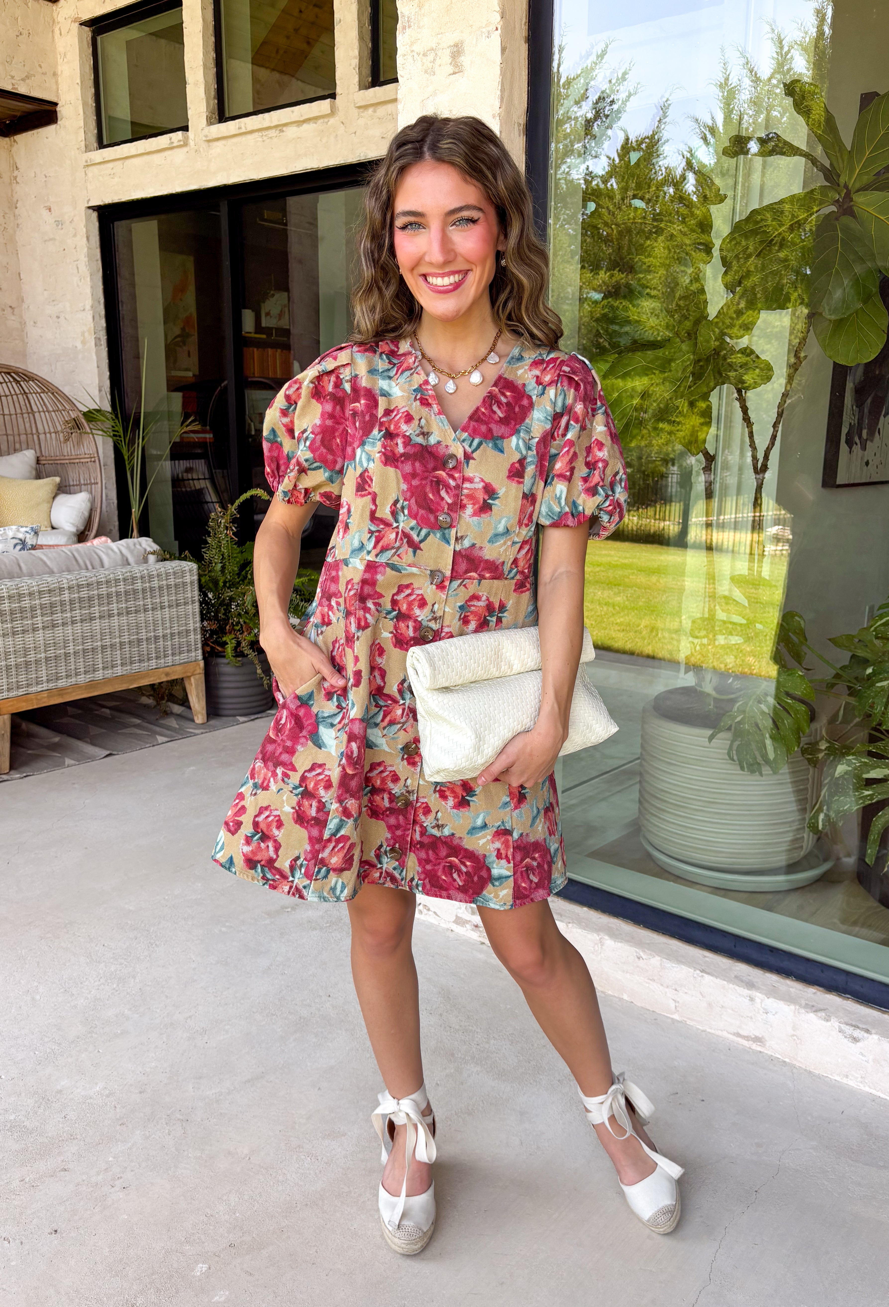 Fall florals meet everyday comfort in this effortlessly charming dress. Crafted from soft camel denim, this beautiful dress features a colorful floral print with rich burgundy and teal blooms that add the perfect pop of seasonal color. The flattering v-neckline and button-front design create a timeless silhouette, while the back elastic waist offers a comfortable, easy fit. 