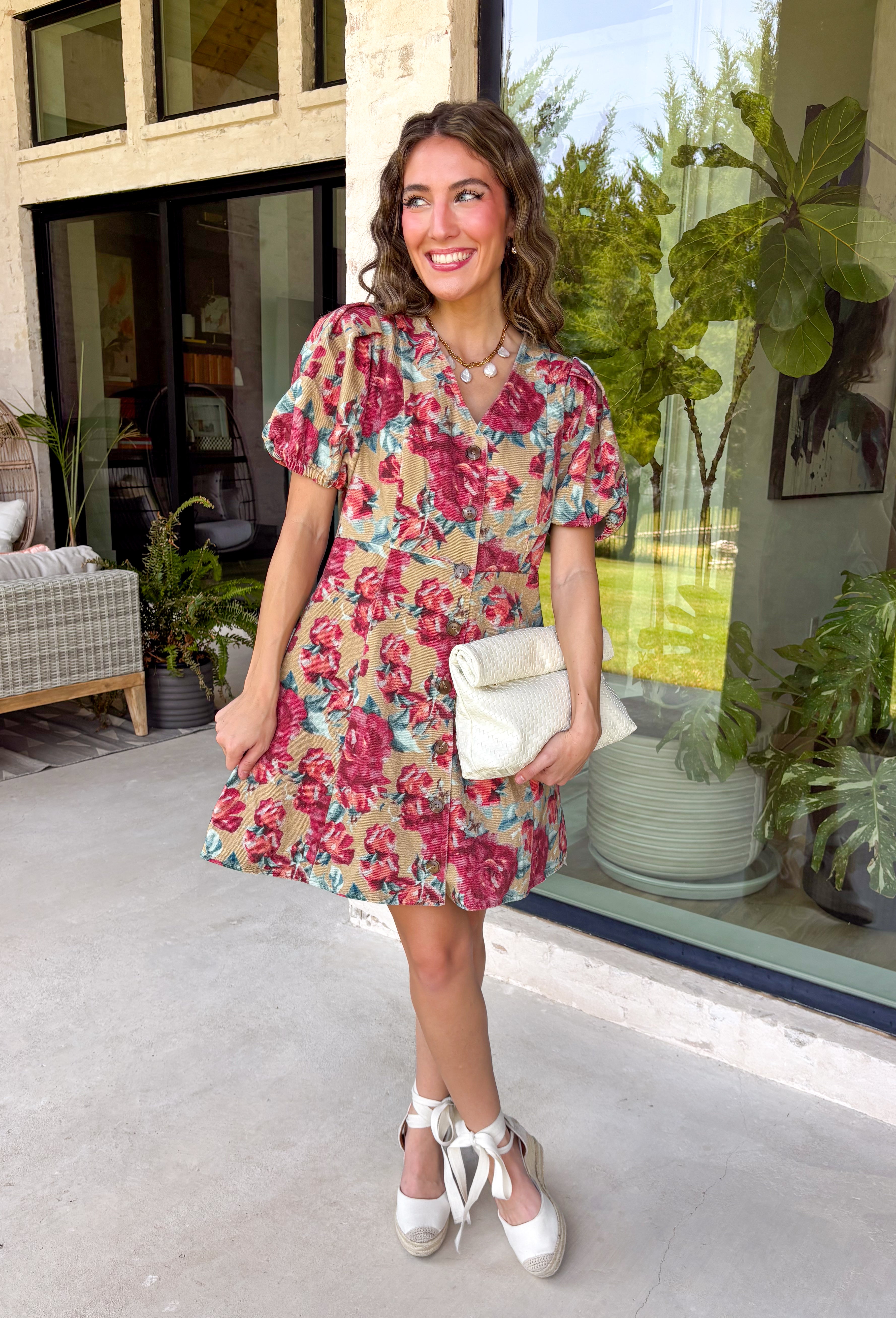 Fall florals meet everyday comfort in this effortlessly charming dress. Crafted from soft camel denim, this beautiful dress features a colorful floral print with rich burgundy and teal blooms that add the perfect pop of seasonal color. The flattering v-neckline and button-front design create a timeless silhouette, while the back elastic waist offers a comfortable, easy fit. 