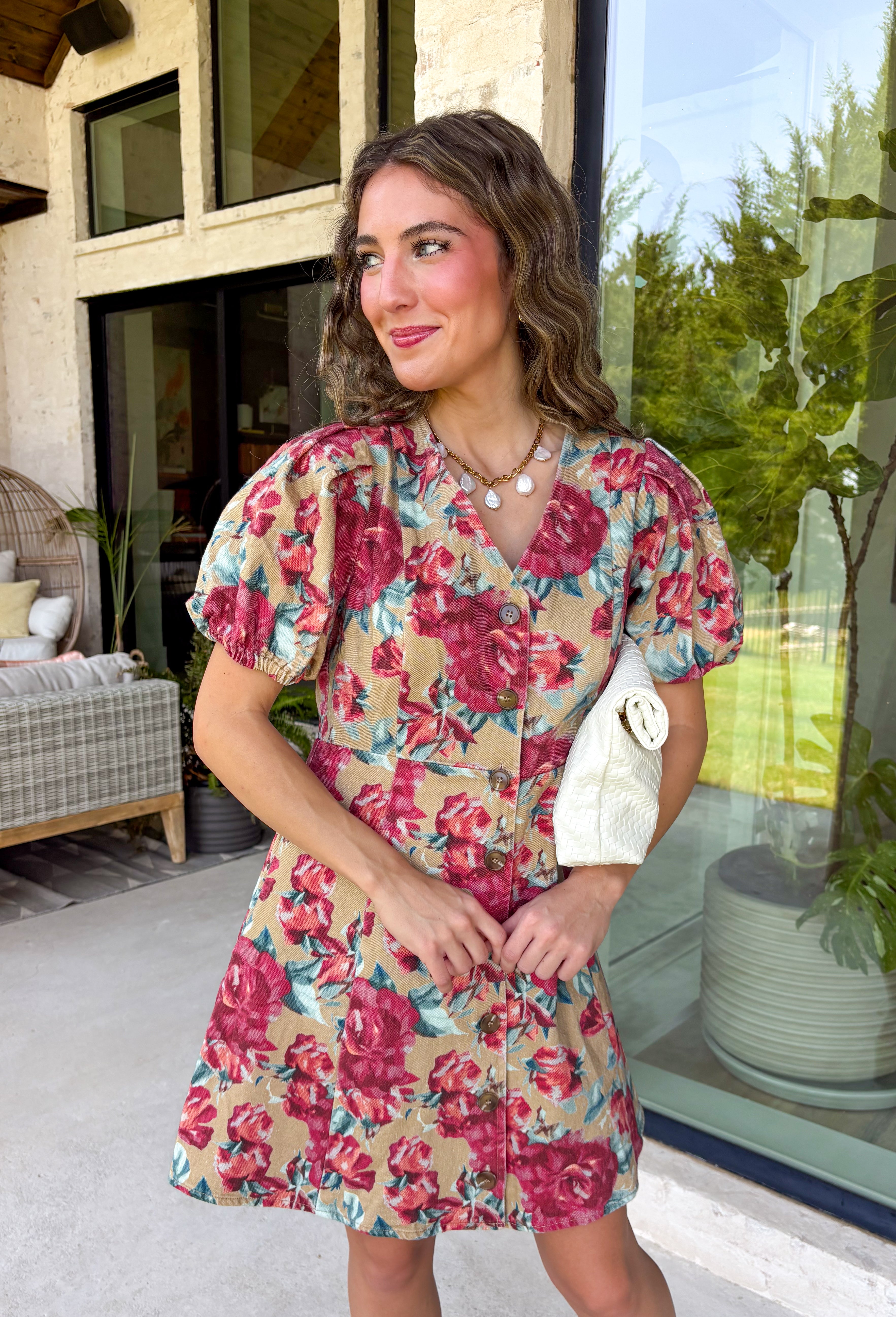 Fall florals meet everyday comfort in this effortlessly charming dress. Crafted from soft camel denim, this beautiful dress features a colorful floral print with rich burgundy and teal blooms that add the perfect pop of seasonal color. The flattering v-neckline and button-front design create a timeless silhouette, while the back elastic waist offers a comfortable, easy fit. 