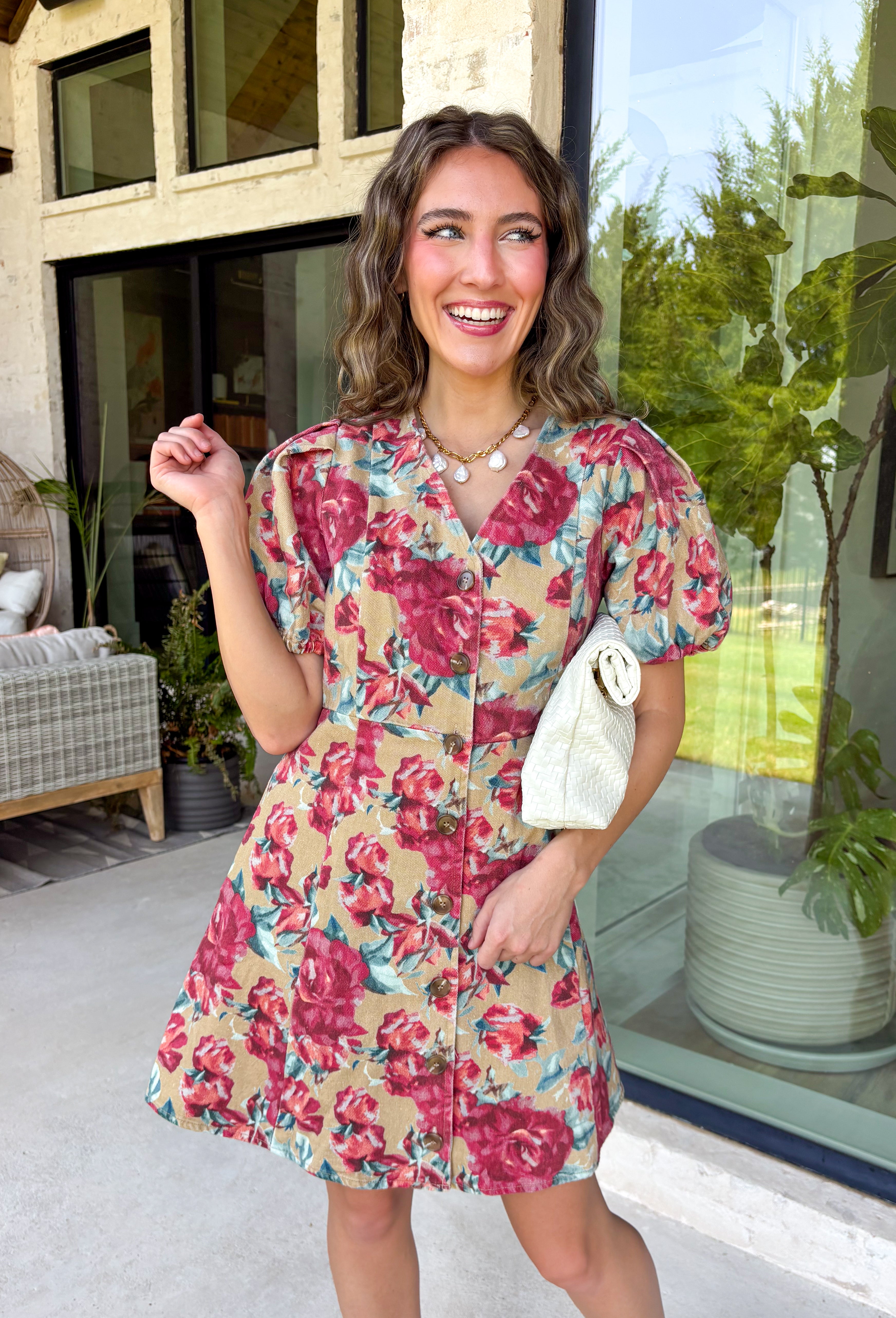 Fall florals meet everyday comfort in this effortlessly charming dress. Crafted from soft camel denim, this beautiful dress features a colorful floral print with rich burgundy and teal blooms that add the perfect pop of seasonal color. The flattering v-neckline and button-front design create a timeless silhouette, while the back elastic waist offers a comfortable, easy fit. 