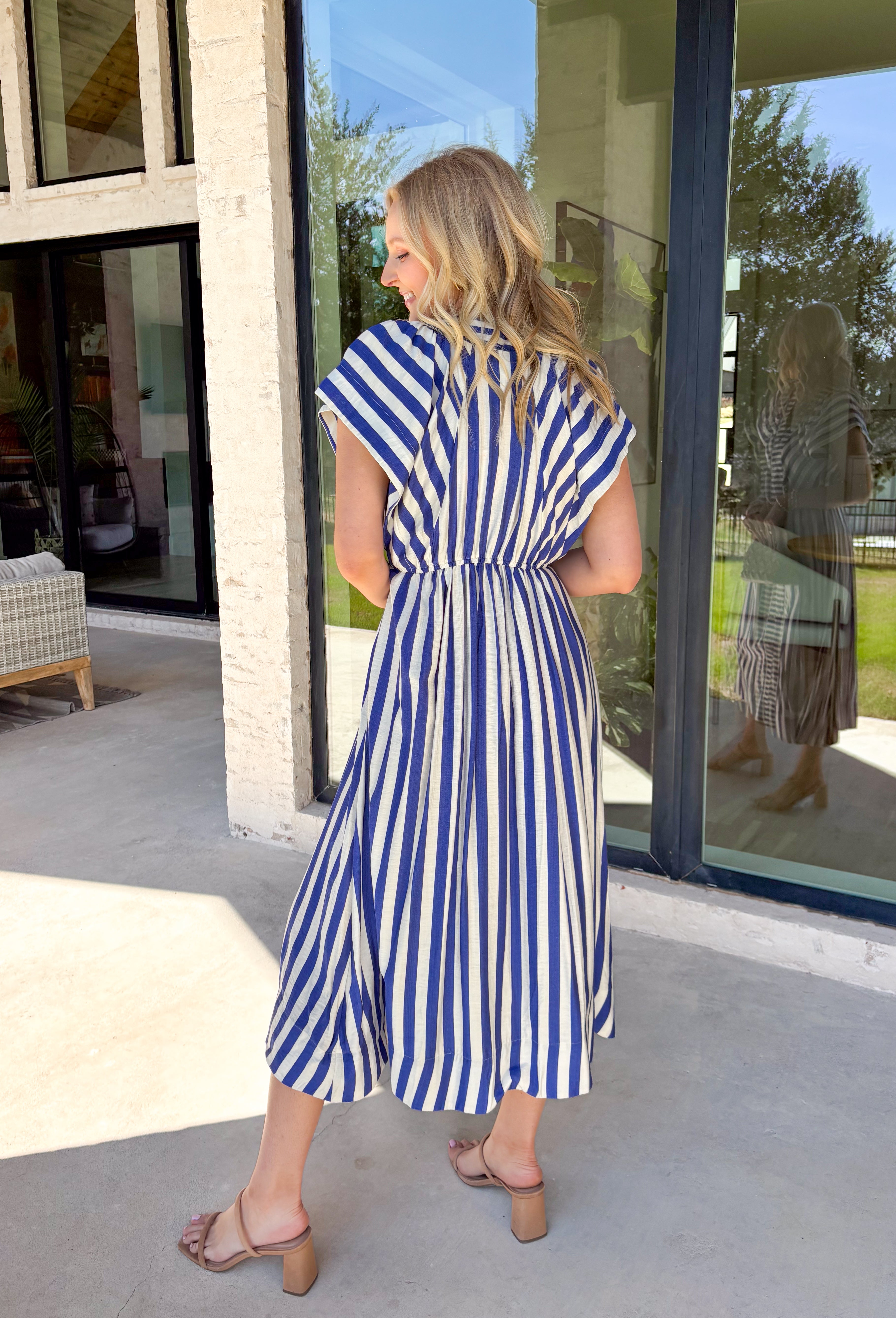 Say hello to your new spring go-to! This royal blue and white striped midi dress by Umgee is giving all the crisp, sunny-day vibes with a classic button down look that feels effortless and put-together. The bold stripes keep it timeless, while the midi length makes it easy to dress up or down for everything from brunch plans to weekend errands. It features fabricated buttons for that polished finish, plus elastic in the back for a comfy, flattering fit that moves with you.