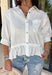 Crisp, classic, and perfect for spring styling, this white short sleeve button-down top by Entro is an easy closet staple with a sweet twist. The structured button-front design keeps it polished, while the ruffle hem adds a soft, feminine touch that elevates the look. Finished with a chest pocket and buttoned sleeve cuffs, this top is lightweight, versatile, and effortless to dress up or down for the season.