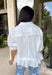 Crisp, classic, and perfect for spring styling, this white short sleeve button-down top by Entro is an easy closet staple with a sweet twist. The structured button-front design keeps it polished, while the ruffle hem adds a soft, feminine touch that elevates the look. Finished with a chest pocket and buttoned sleeve cuffs, this top is lightweight, versatile, and effortless to dress up or down for the season.