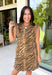Make a statement this season with this effortlessly chic denim zebra print dress. Designed in a rich brown hue with a timeless zebra print, this sleeveless style is the perfect blend of bold and sophisticated. The shoulder detailing adds a modern touch, while the structured silhouette creates an effortlessly polished look.