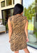 Make a statement this season with this effortlessly chic denim zebra print dress. Designed in a rich brown hue with a timeless zebra print, this sleeveless style is the perfect blend of bold and sophisticated. The shoulder detailing adds a modern touch, while the structured silhouette creates an effortlessly polished look.