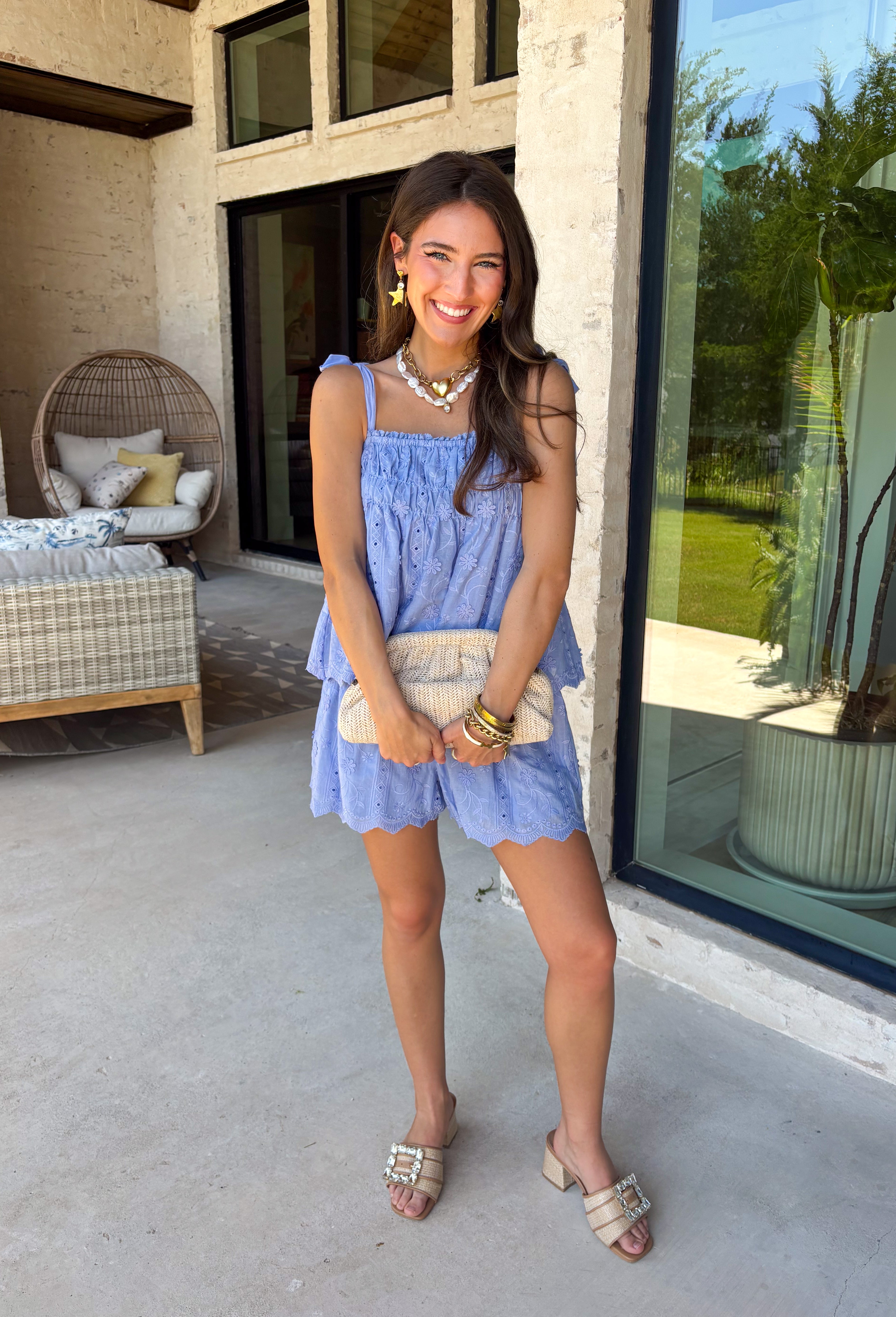 This light blue eyelet lace set is the definition of a dreamy summer outfit! The delicate eyelet detail paired with scalloped hems gives it that soft, feminine feel, while the matching set makes getting dressed effortless. The sleeveless top features smocking along the front and adjustable tie straps for the perfect fit, and the elastic waist shorts keep things comfortable for all-day wear. Lightweight and breathable in 100% cotton, it’s perfect for everything from vacation mornings to casual days out