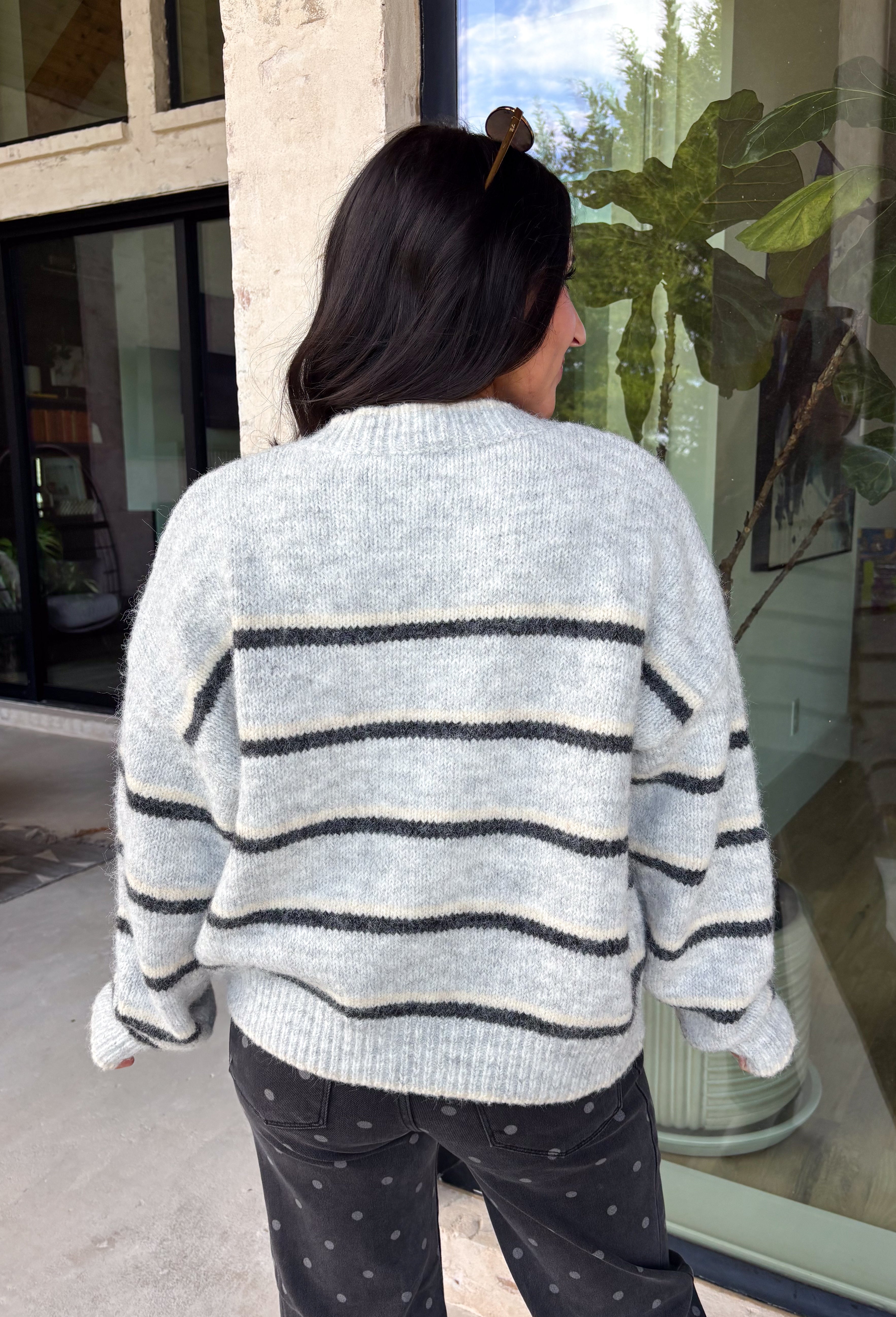 Cozy up in timeless style with this beautiful cardigan from Hyfve. Designed in a soft light gray knit with classic black and cream stripes, this button-down sweater is the perfect layering piece for the season. Ribbed detailing throughout adds texture and a polished finish, while the ultra-soft knit blend keeps you warm and comfortable without feeling bulky. Whether you wear it buttoned as a sweater or layered over your favorite basics, this versatile cardigan is one you'll reach for again and again.