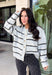 Cozy up in timeless style with this beautiful cardigan from Hyfve. Designed in a soft light gray knit with classic black and cream stripes, this button-down sweater is the perfect layering piece for the season. Ribbed detailing throughout adds texture and a polished finish, while the ultra-soft knit blend keeps you warm and comfortable without feeling bulky. Whether you wear it buttoned as a sweater or layered over your favorite basics, this versatile cardigan is one you'll reach for again and again.