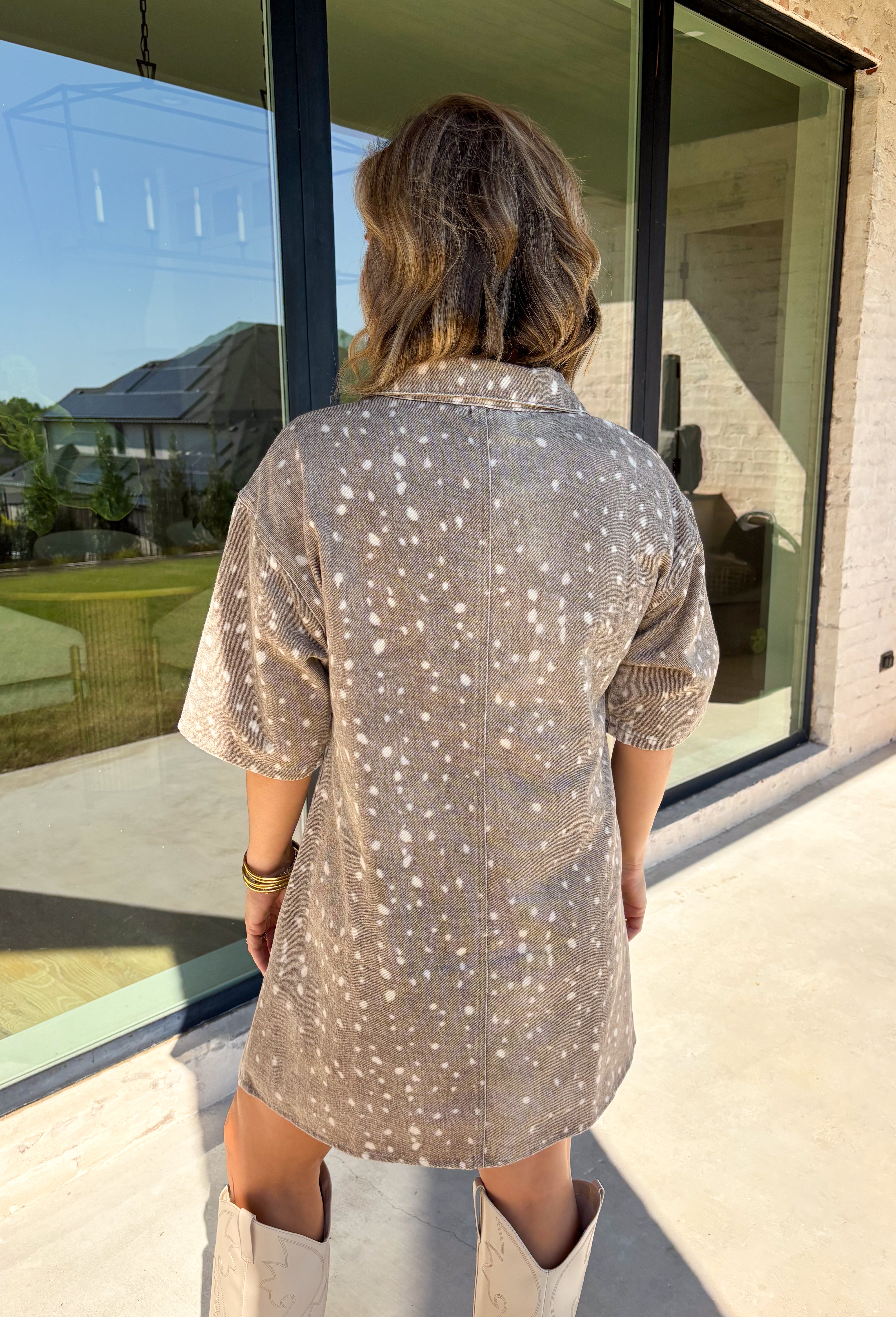 Take a walk on the playful side of fall with this mocha denim dress from New In. The warm mocha shade is covered in an ivory fawn-inspired spotted print, giving classic denim an unexpected woodland twist that’s perfect for the season. A collared neckline and front button closure keep the silhouette classic, while short sleeves make it a great pick for warmer autumn afternoons. Front pockets add a casual, functional touch and complement the denim construction.