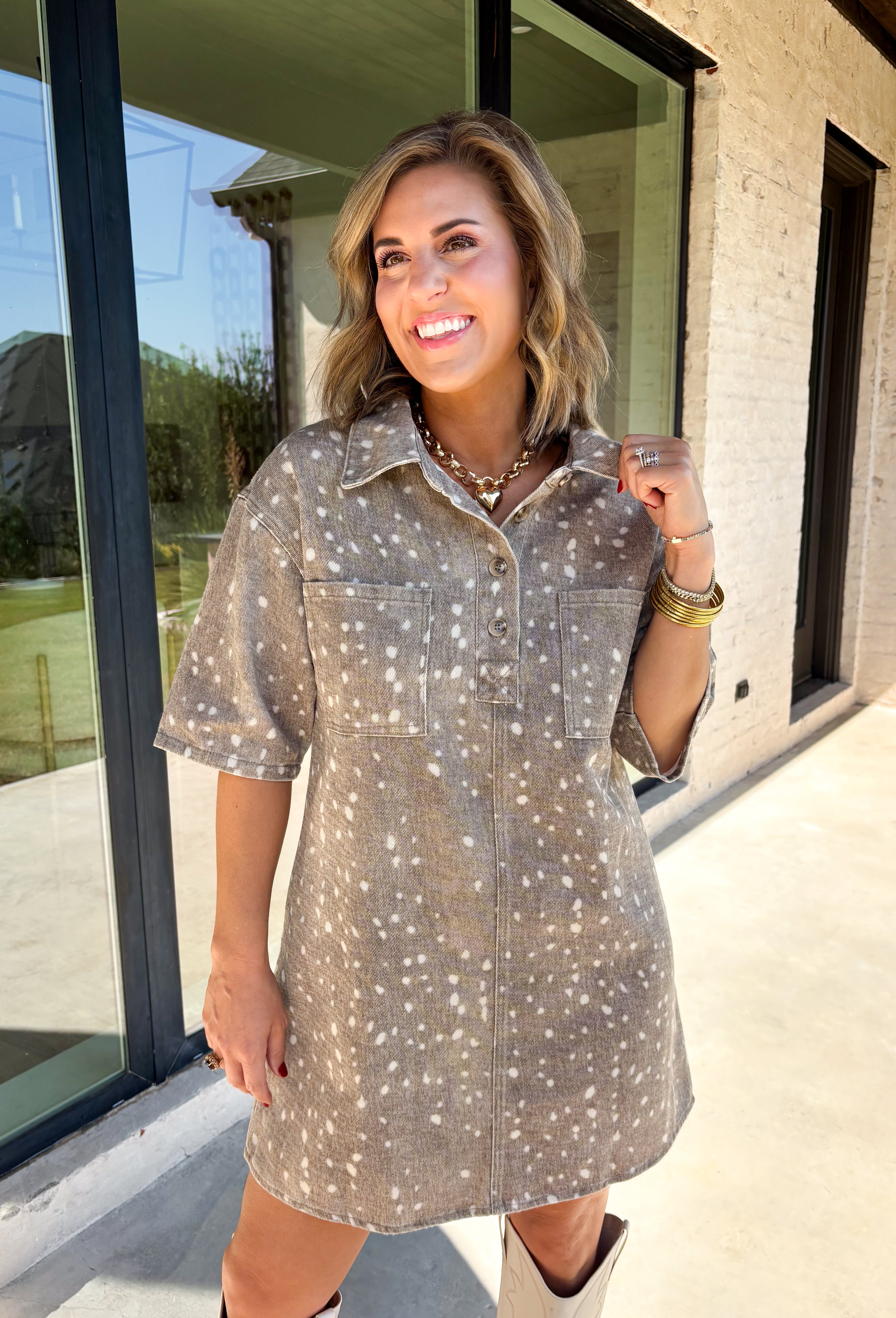 Take a walk on the playful side of fall with this mocha denim dress from New In. The warm mocha shade is covered in an ivory fawn-inspired spotted print, giving classic denim an unexpected woodland twist that’s perfect for the season. A collared neckline and front button closure keep the silhouette classic, while short sleeves make it a great pick for warmer autumn afternoons. Front pockets add a casual, functional touch and complement the denim construction.